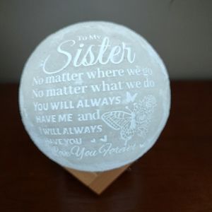 Moon light that has a sister quote on it and lights up two different colors